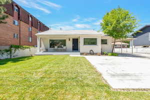 View of front of property featuring covered porch. Carport and detached garage for covered parking, and additional uncovered parking.