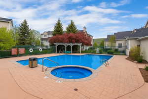 Community pool with a community hot tub, a patio, and a pergola