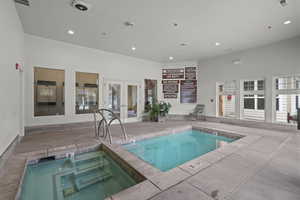 Indoor pool featuring french doors