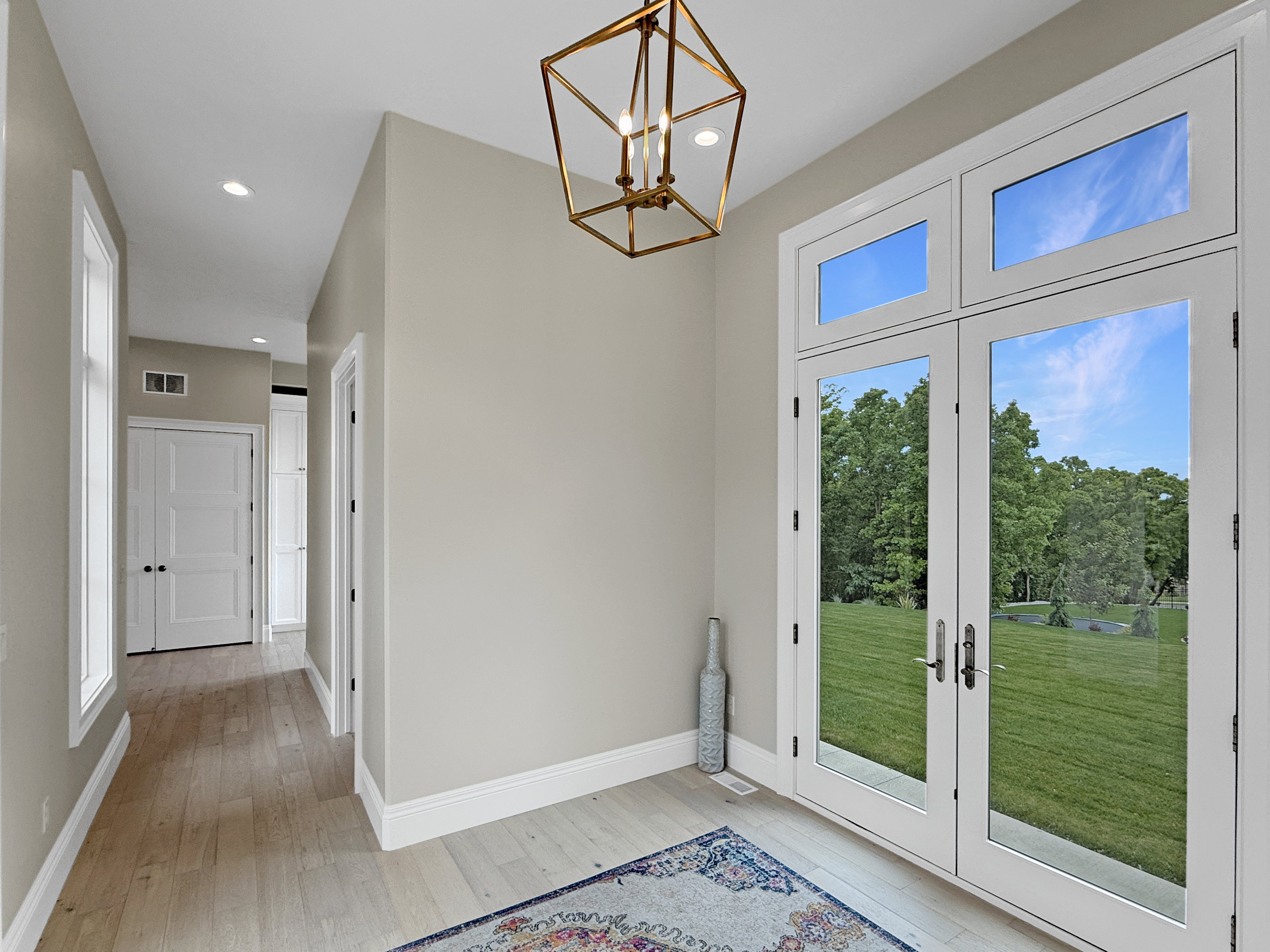 Doorway to outside with light wood-style floors, a chandelier, recessed lighting, baseboards, and french doors