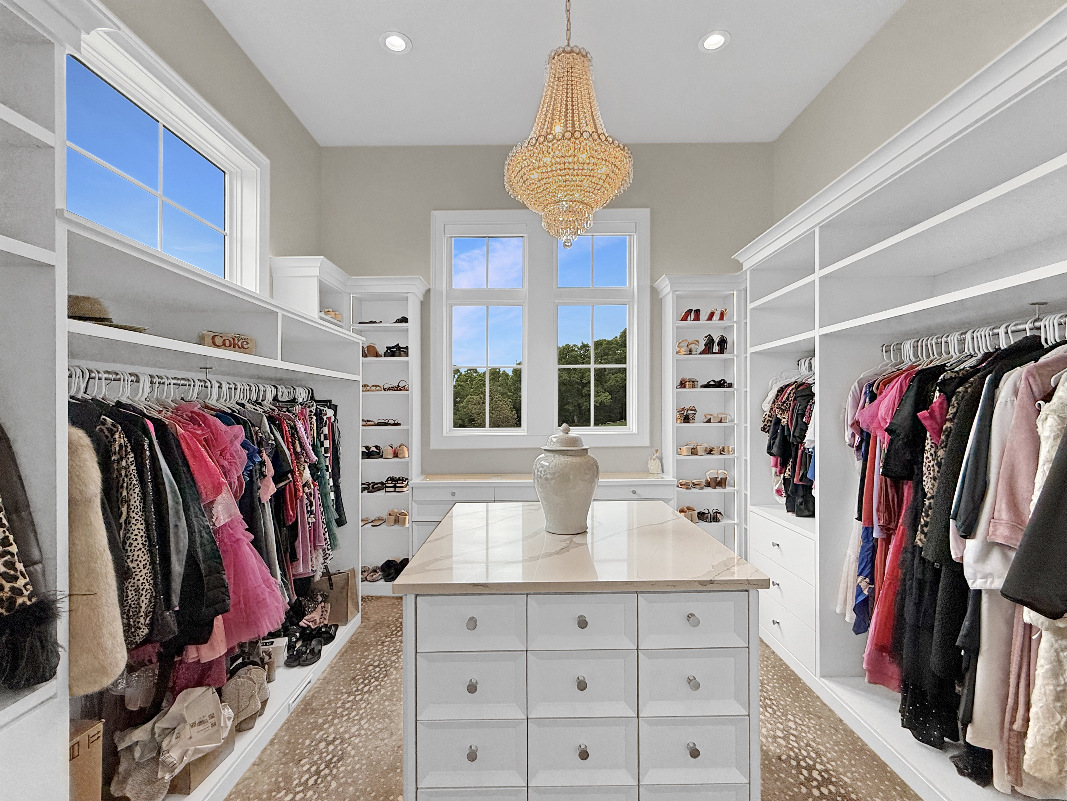 Walk in closet with a chandelier