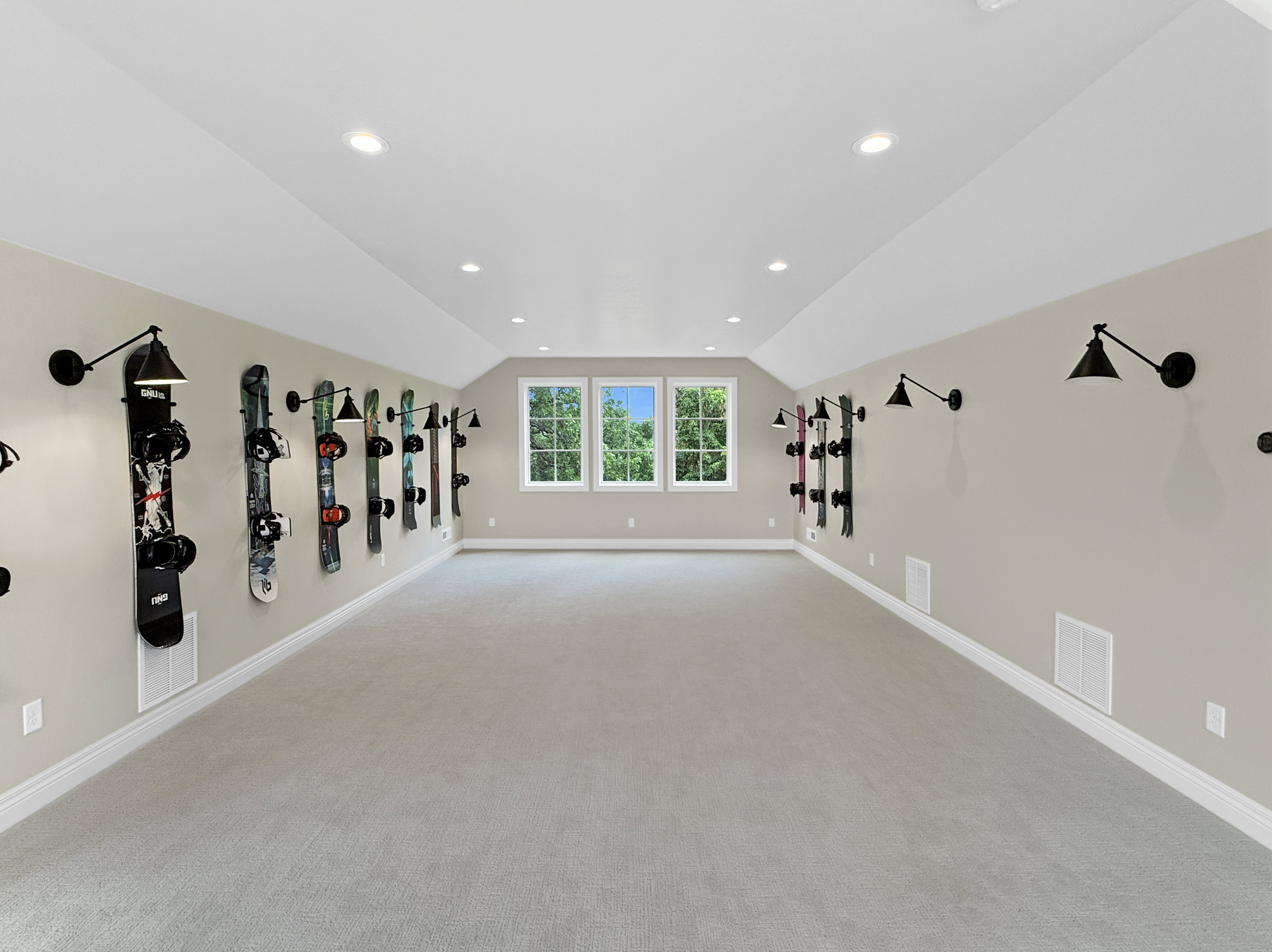 Above garage living room featuring carpet floors, vaulted ceiling, baseboards, and recessed lighting