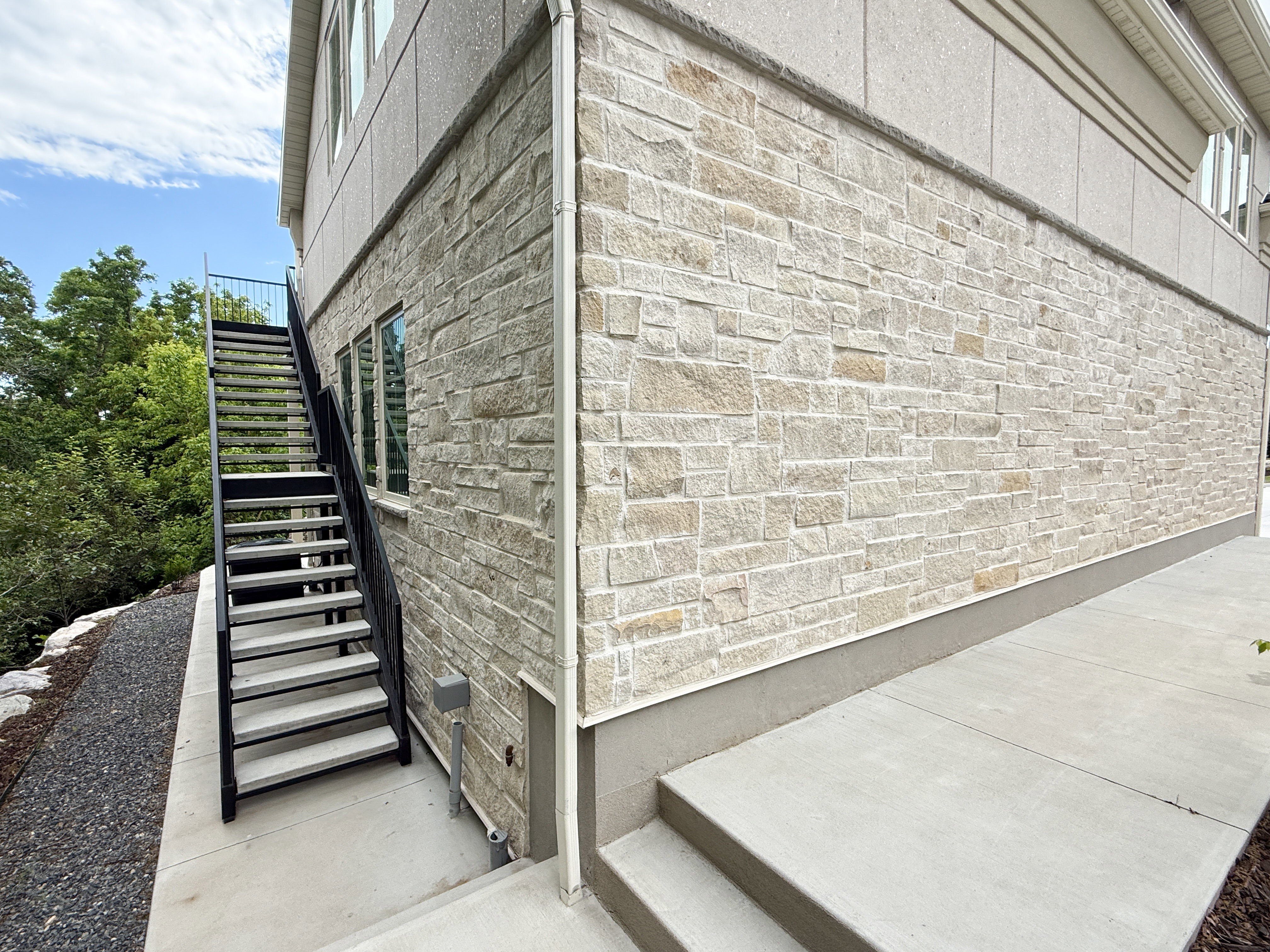 View of home's exterior featuring stairway