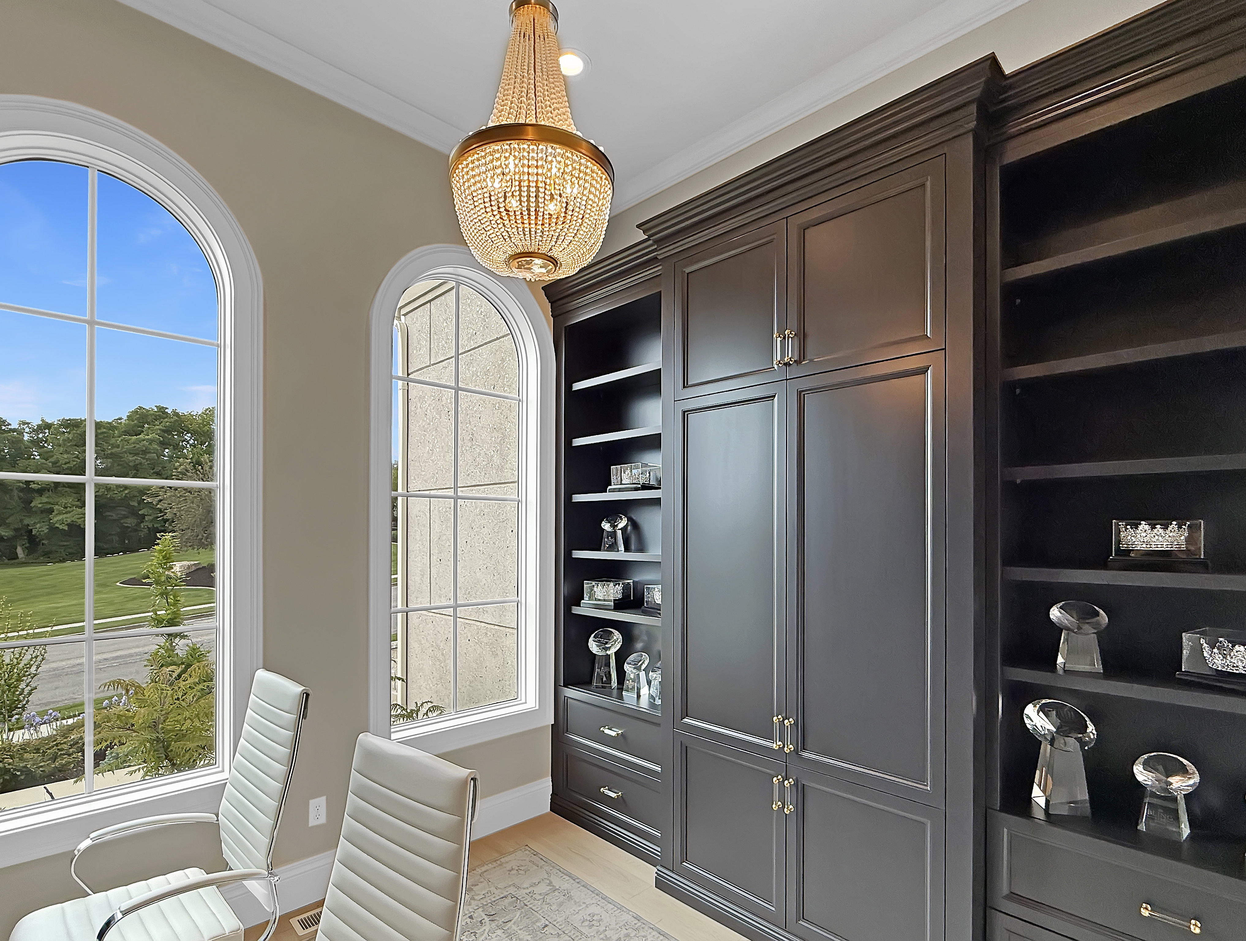 Walk in closet with a chandelier and light wood-style flooring