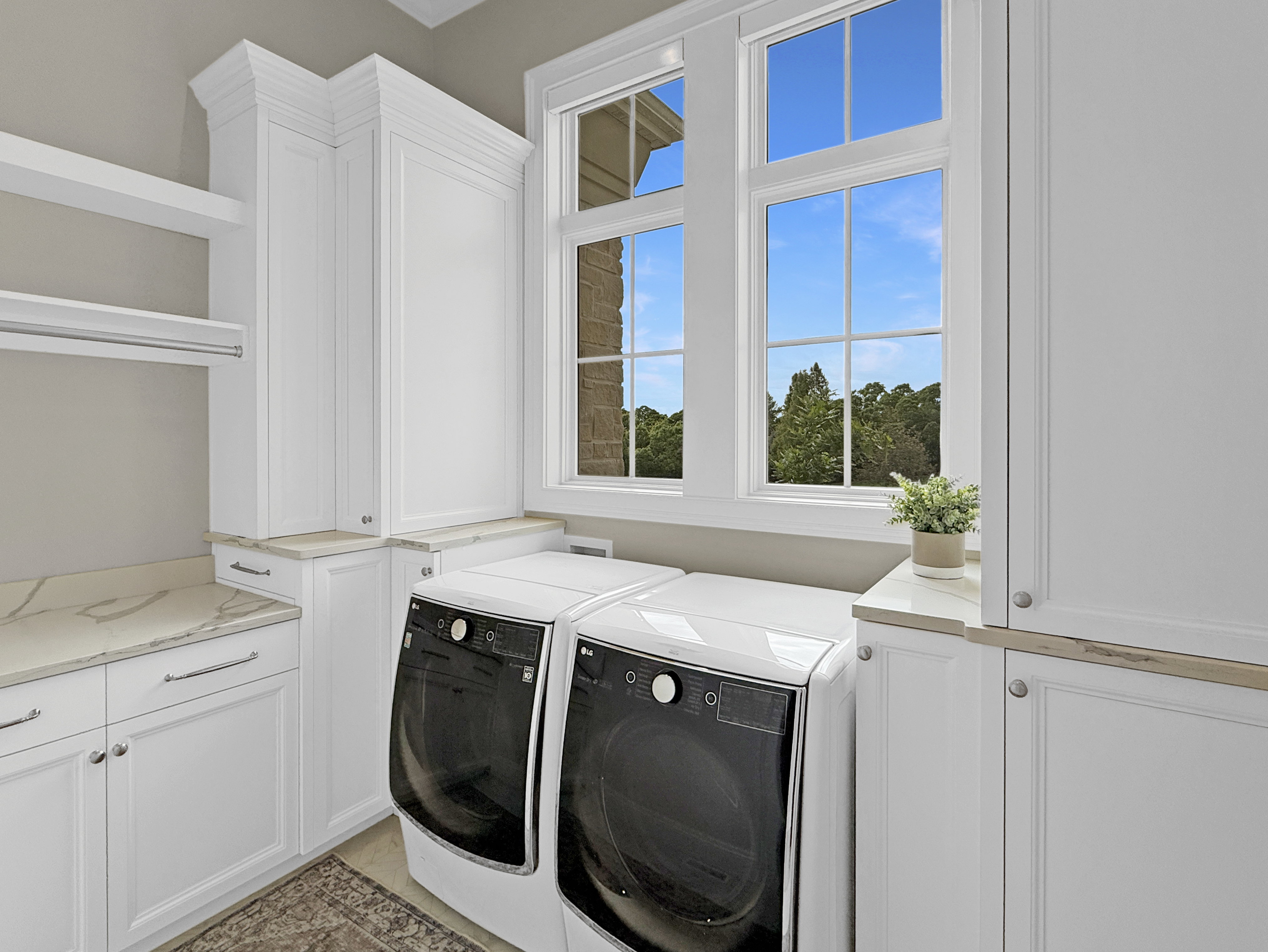 Laundry area featuring washing machine and clothes dryer and cabinet space