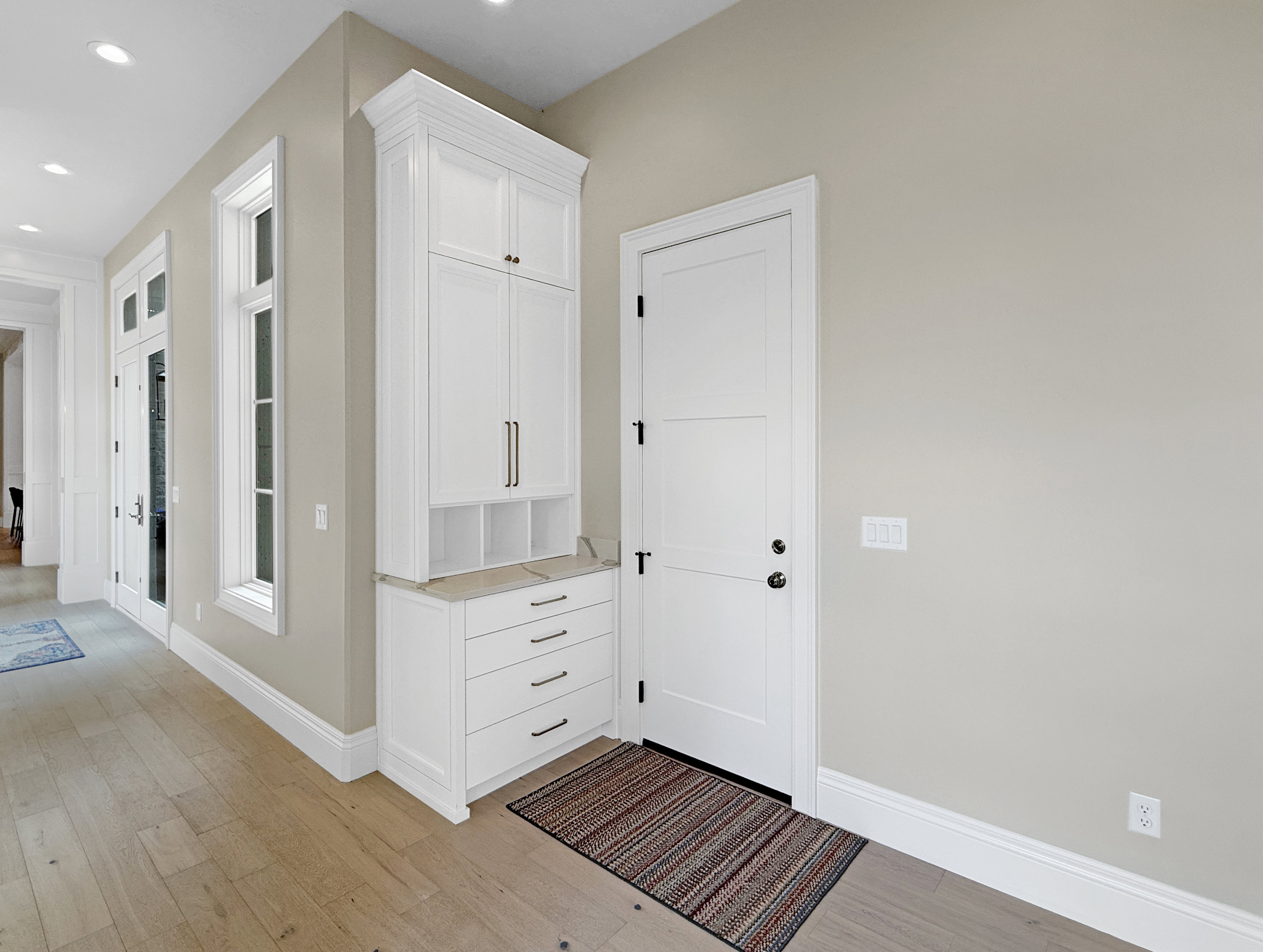 Garage entrance featuring light wood-style floors, baseboards, and recessed lighting