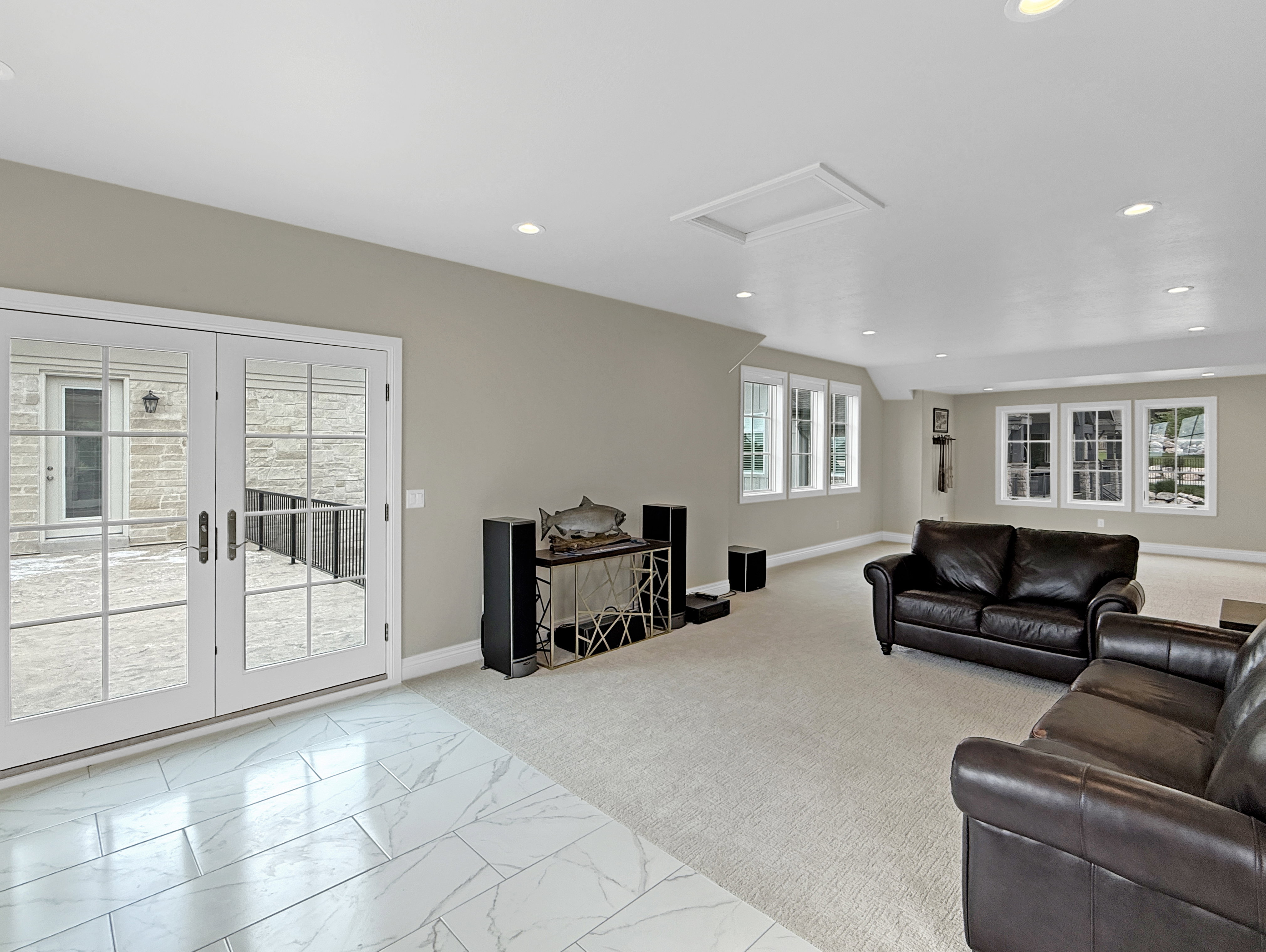 Above garage living room featuring carpet floors, vaulted ceiling, baseboards, and recessed lighting