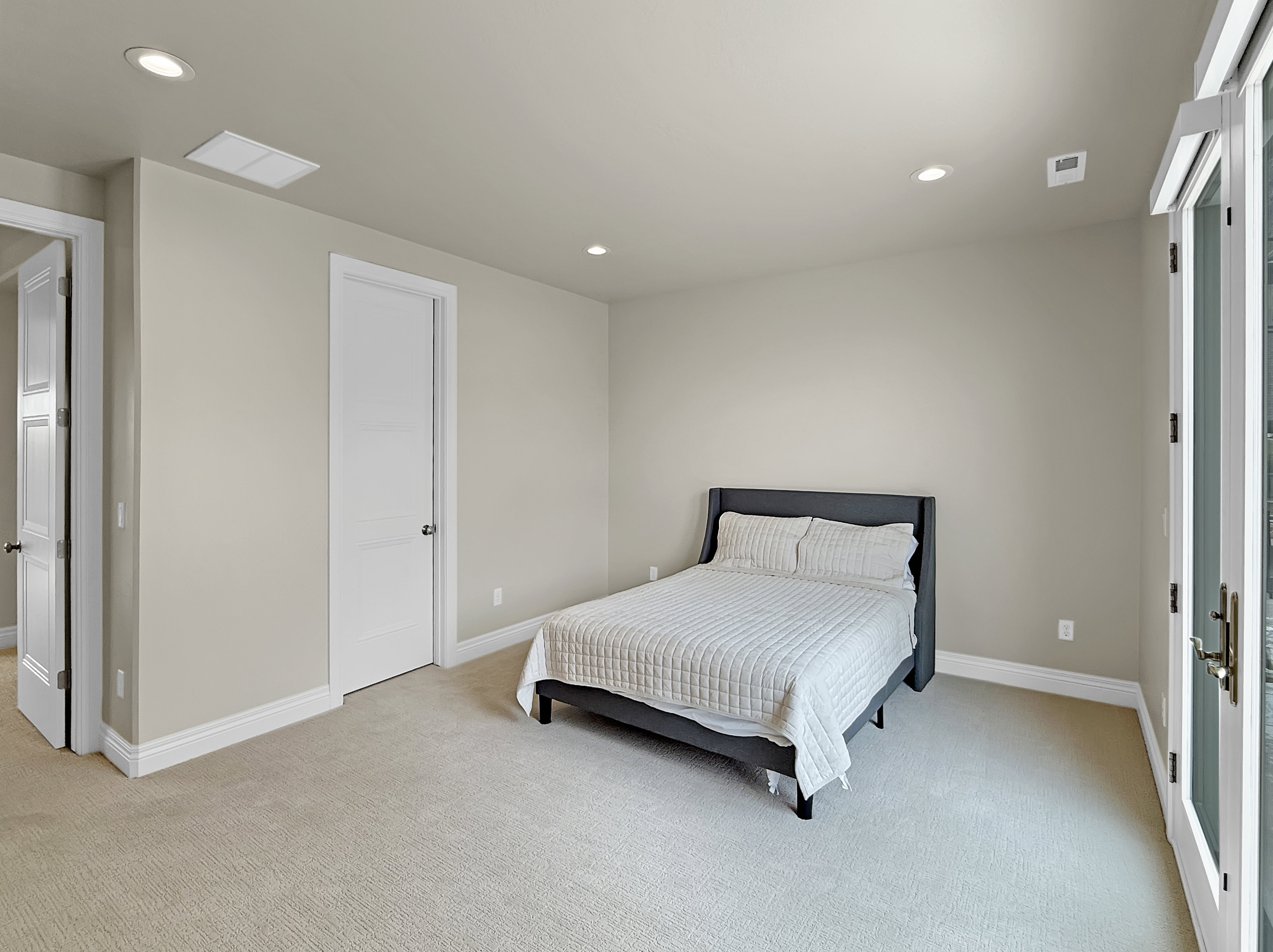 Bedroom with light colored carpet, recessed lighting, and baseboards