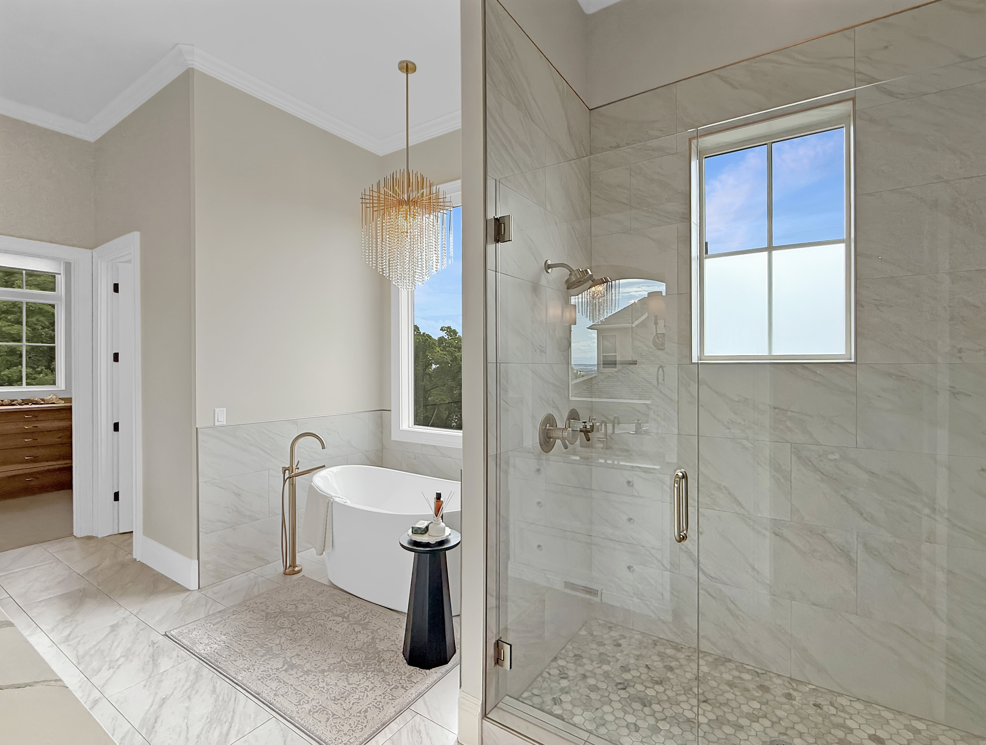 Bathroom with crown molding, a soaking tub, and a stall shower