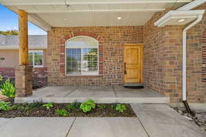 Doorway to property featuring brick siding