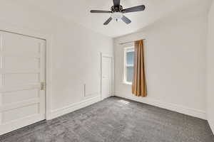 Spare room featuring carpet and a ceiling fan