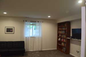 Living area featuring carpet flooring, recessed lighting, and baseboards