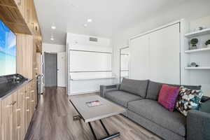 Living room featuring dark wood finished floors and recessed lighting