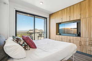 Bedroom featuring wood finished floors and access to outside