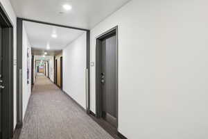Corridor with carpet floors and baseboards