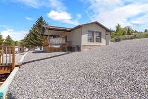 View of rear property exterior with covered deck