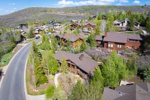 Aerial view of property's location with nearby suburban area and mountains