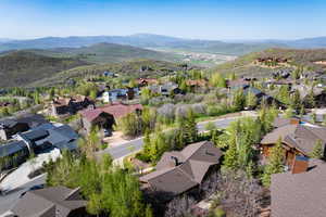 Aerial view of property's location with nearby suburban area and a mountain backdrop