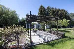 View of community with a patio, a pergola, a yard, and a fire pit