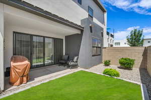 Rear view of property with stucco siding and a patio area