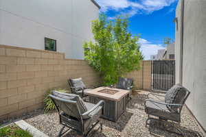 Fenced backyard with a fire pit and a gate
