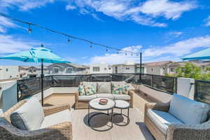 View of patio featuring an outdoor living space, a residential view, and a balcony