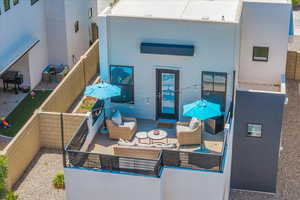 Back of property with an outdoor living space and a patio area