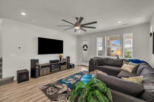 Living area featuring a ceiling fan, light wood-style flooring, recessed lighting, and baseboards