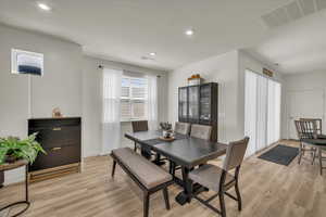 Dining space featuring light wood finished floors, recessed lighting, and baseboards
