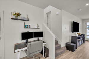 Office with light wood-style flooring and baseboards