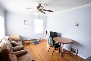 Office featuring hardwood / wood-style flooring, a ceiling fan, baseboards, and crown molding