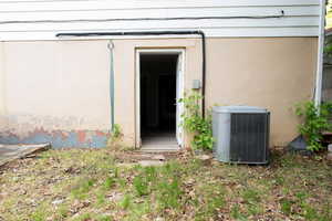 Doorway to property with cooling unit