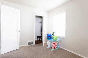 Game room featuring carpet flooring and baseboards