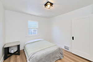 Bedroom featuring light wood finished floors and baseboards