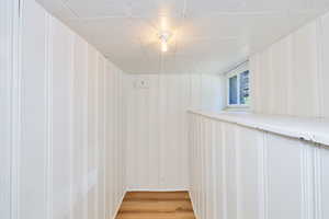 Basement featuring light lvp floors and a decorative wall