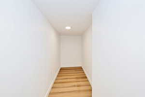 Corridor featuring light lvp flooring and baseboards