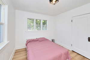 Bedroom featuring light wood-style floors and baseboards