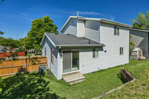 Back of house with entry steps, central air condition unit, and roof with shingles