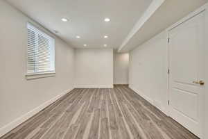 Unfurnished room with light wood-type flooring, recessed lighting, and baseboards
