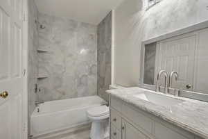 Bathroom featuring vanity,  shower combination, toilet, and wood finished floors