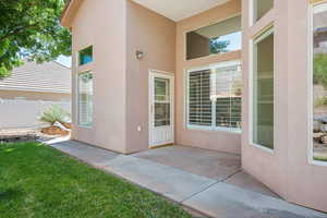 Entrance to property featuring a patio and stucco siding