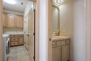 Laundry room with cabinet space and independent washer and dryer