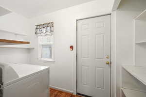 Laundry area with washer/dryer, exterior door, large pantry shelves