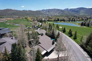 Aerial view of property's location with a water and mountain view and nearby suburban area