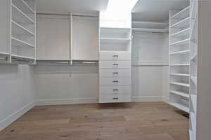 Spacious closet with light wood-style floors