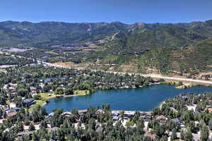 Aerial overview of property's location featuring a water and mountain view