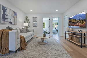 Living room featuring wood finished floors, recessed lighting, and baseboards