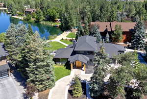 Aerial view of property and surrounding area with a nearby body of water