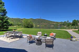 View of patio featuring outdoor dining space and a water and mountain view