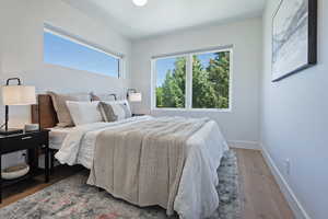 Bedroom featuring wood finished floors and baseboards